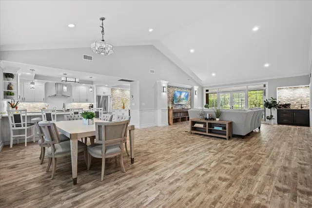 a kitchen with kitchen island white cabinets and stainless steel appliances