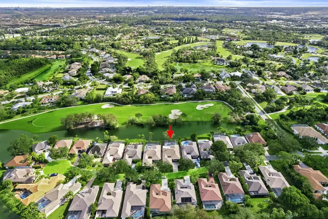 an aerial view of residential houses with outdoor space and parking