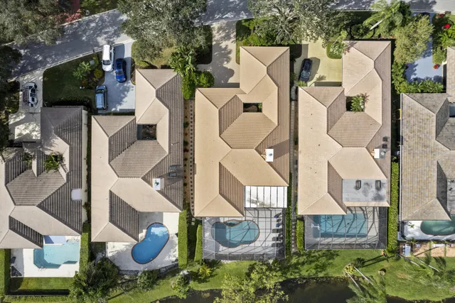 an aerial view of a houses with a swimming pool
