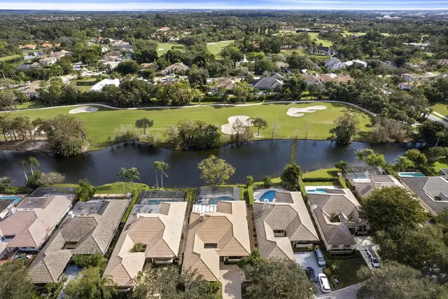 an aerial view of residential houses with outdoor space and swimming pool