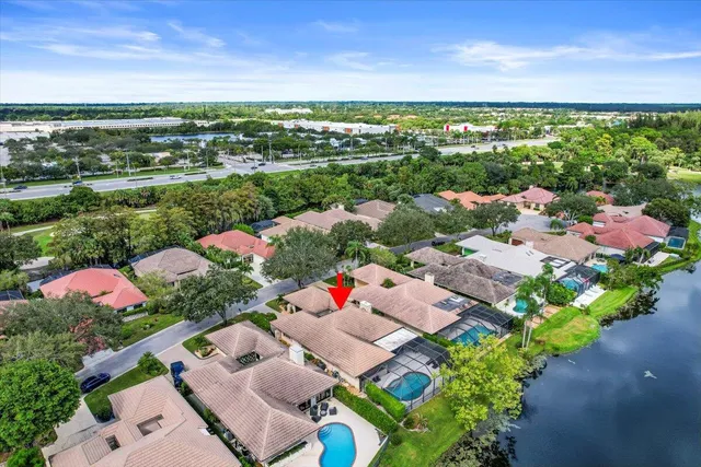 an aerial view of a house with a garden and swimming pool