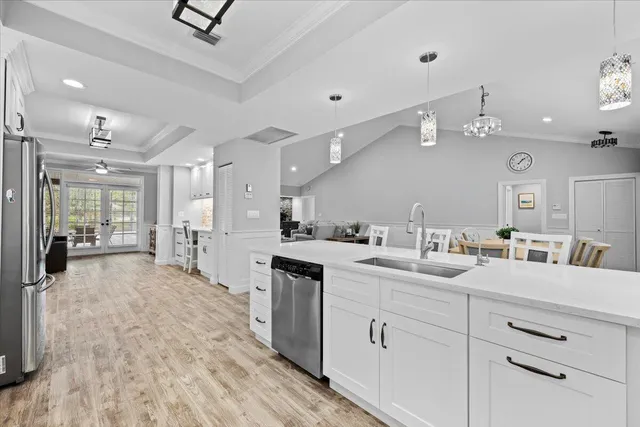 a large white kitchen with a large window