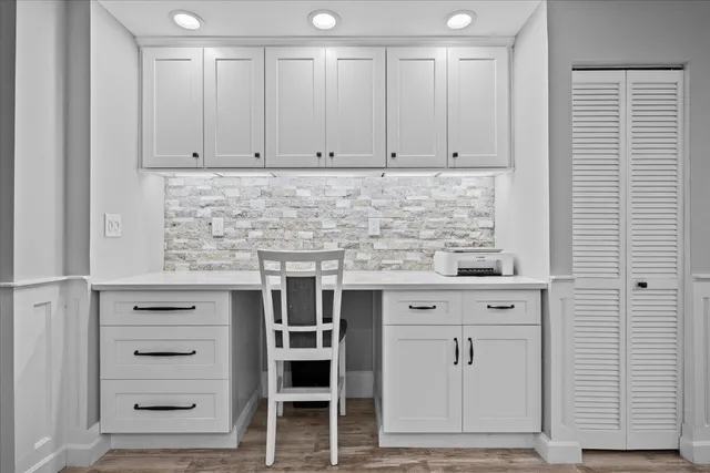 a view of a dining room with furniture and chandelier
