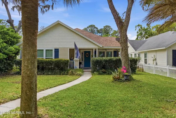 a view of a house with a yard and plants