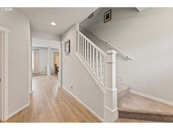 a view of entryway and hall with wooden floor