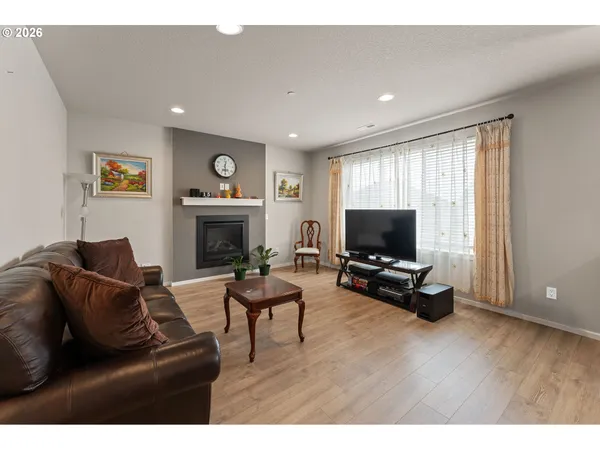 a living room with furniture flat screen tv and a fireplace