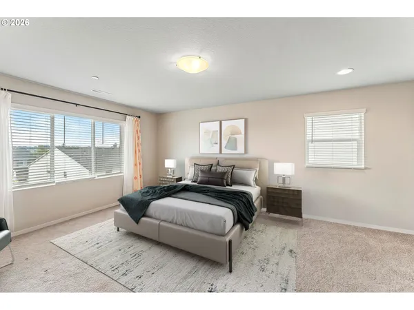 a bedroom with bed and a large window