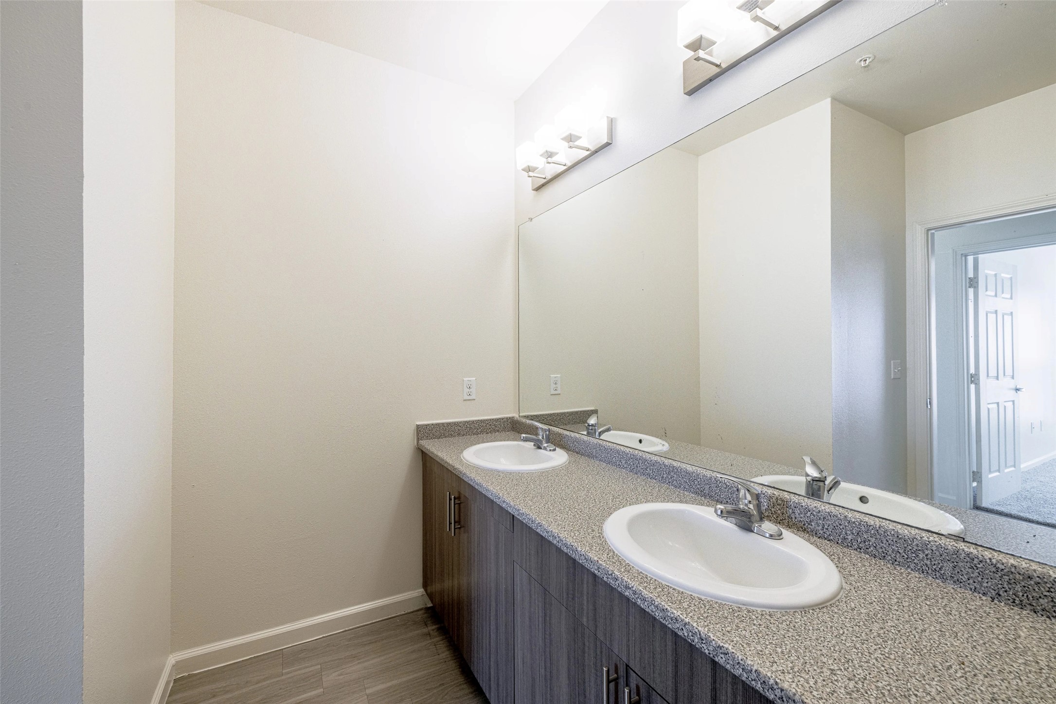 5605 Springdale Road, Unit 444421 Austin, TX 78723 - Photo 11 of 21 a bathroom with a granite countertop sink and a mirror