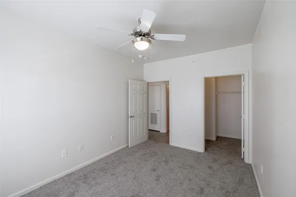 a view of a chandelier fan and closet in a room