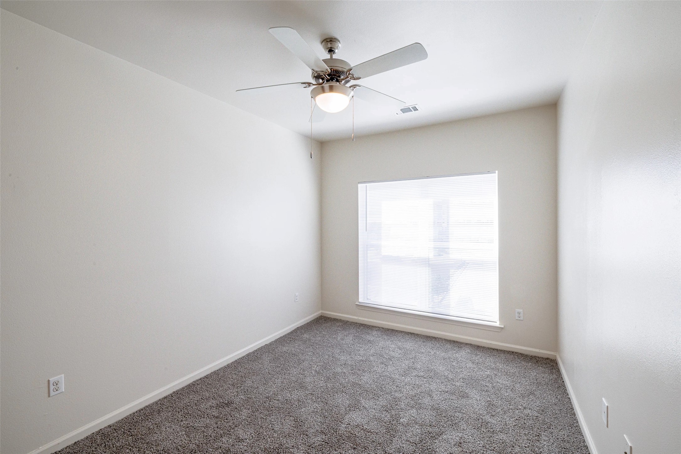 5605 Springdale Road, Unit 444421 Austin, TX 78723 - Photo 13 of 21 an empty room with a window and a ceiling fan