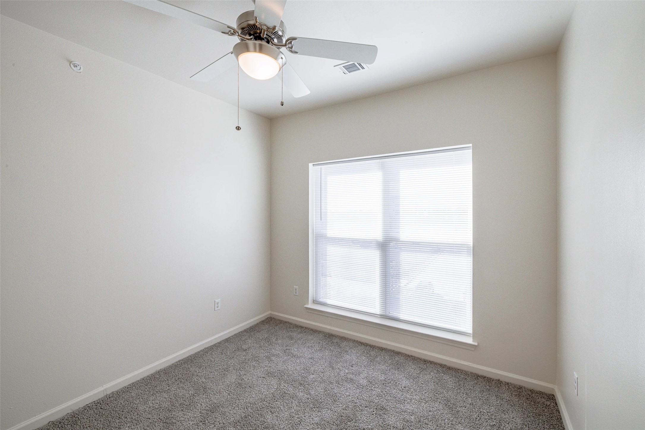 5605 Springdale Road, Unit 444421 Austin, TX 78723 - Photo 15 of 21 an empty room with a window and a fan