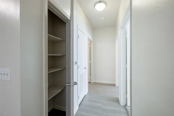 a view of hallway with wooden floor