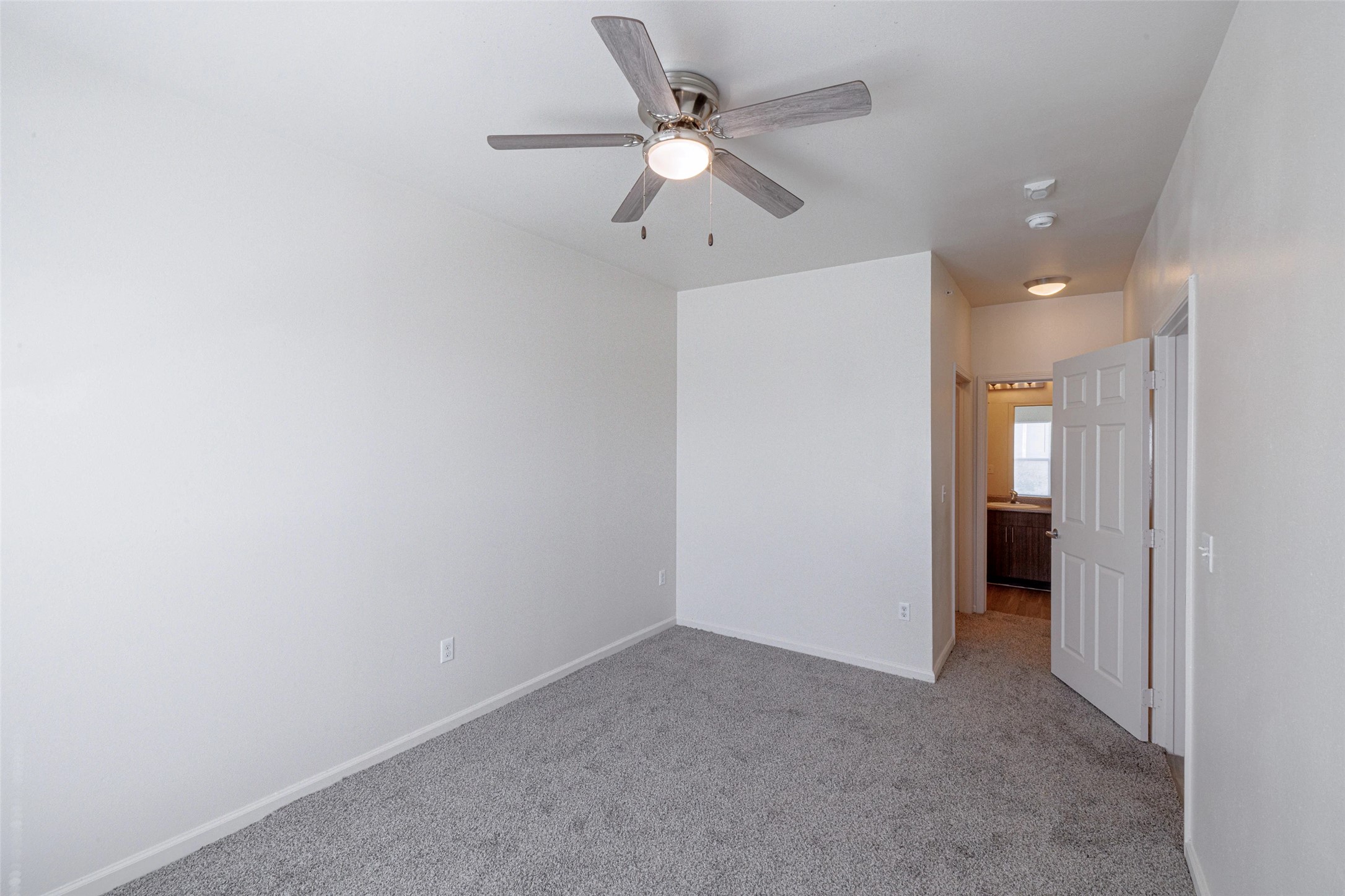 5605 Springdale Road, Unit 444421 Austin, TX 78723 - Photo 7 of 21 an empty room with a ceiling fan and a window