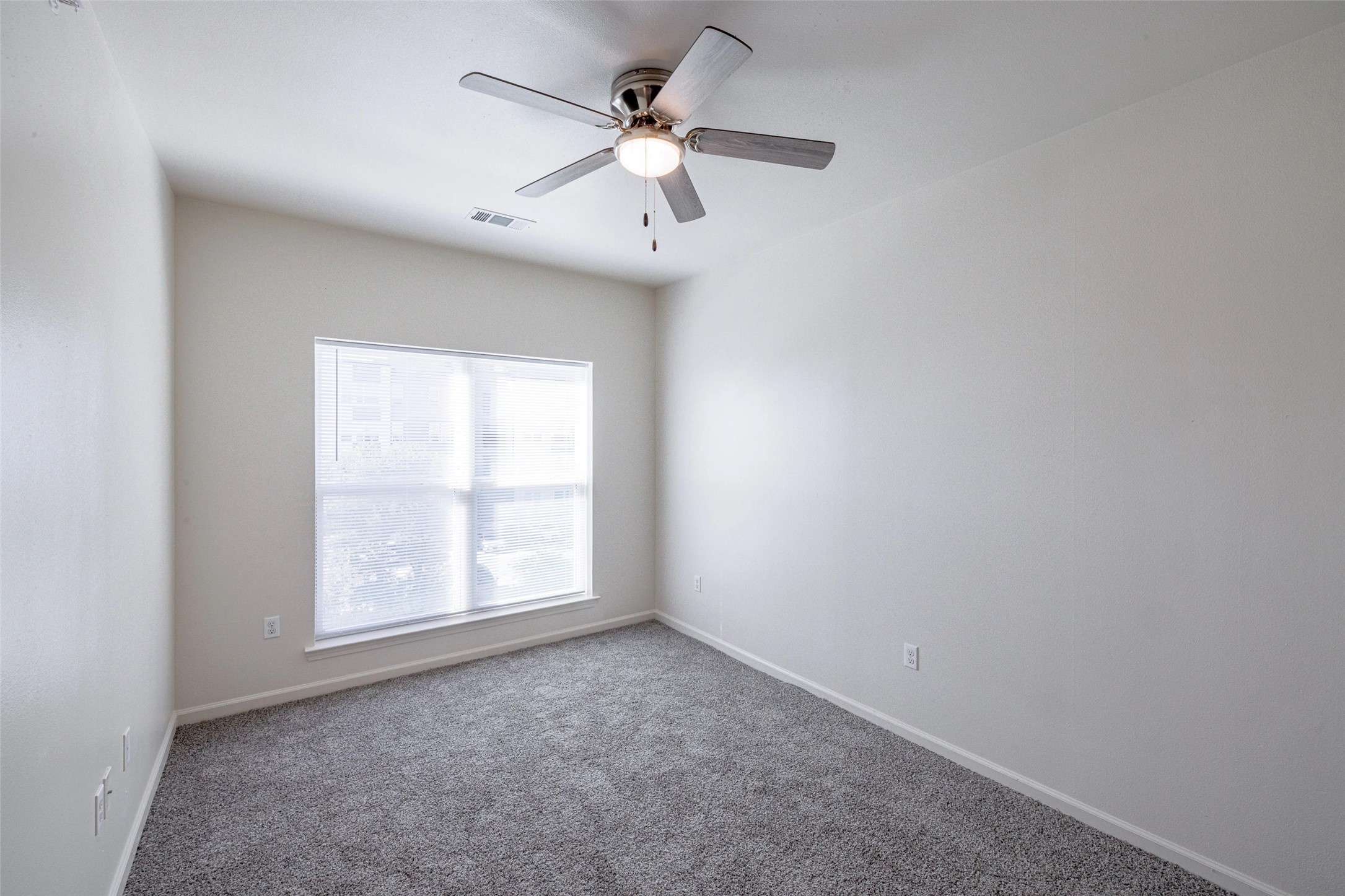 5605 Springdale Road, Unit 444421 Austin, TX 78723 - Photo 8 of 21 an empty room with windows and ceiling fan