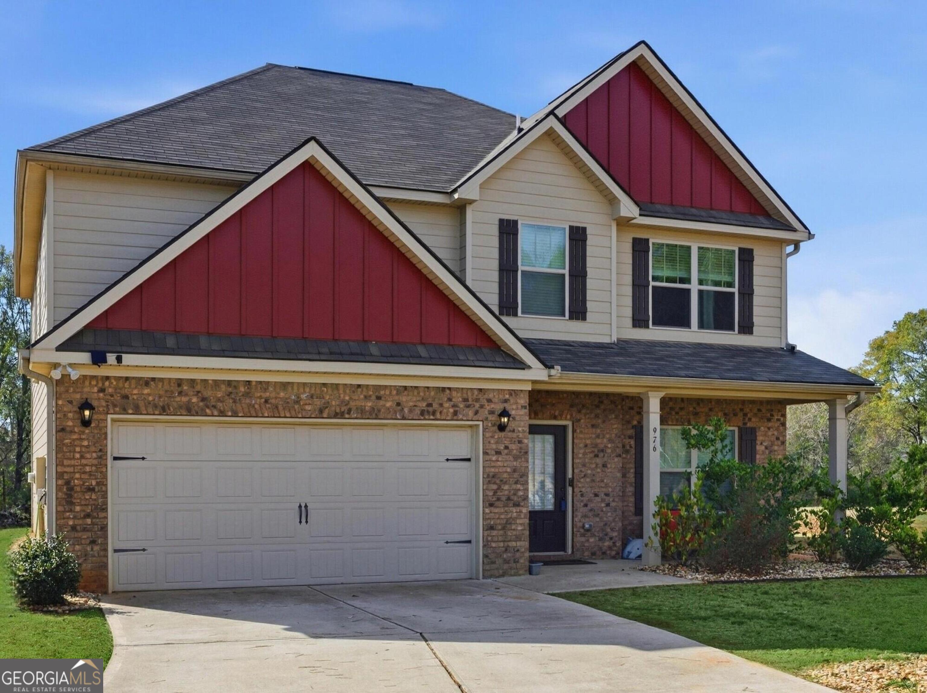 976 Jackson Street Locust Grove, GA 30248 - Photo 1 of 17 a front view of a house with garden