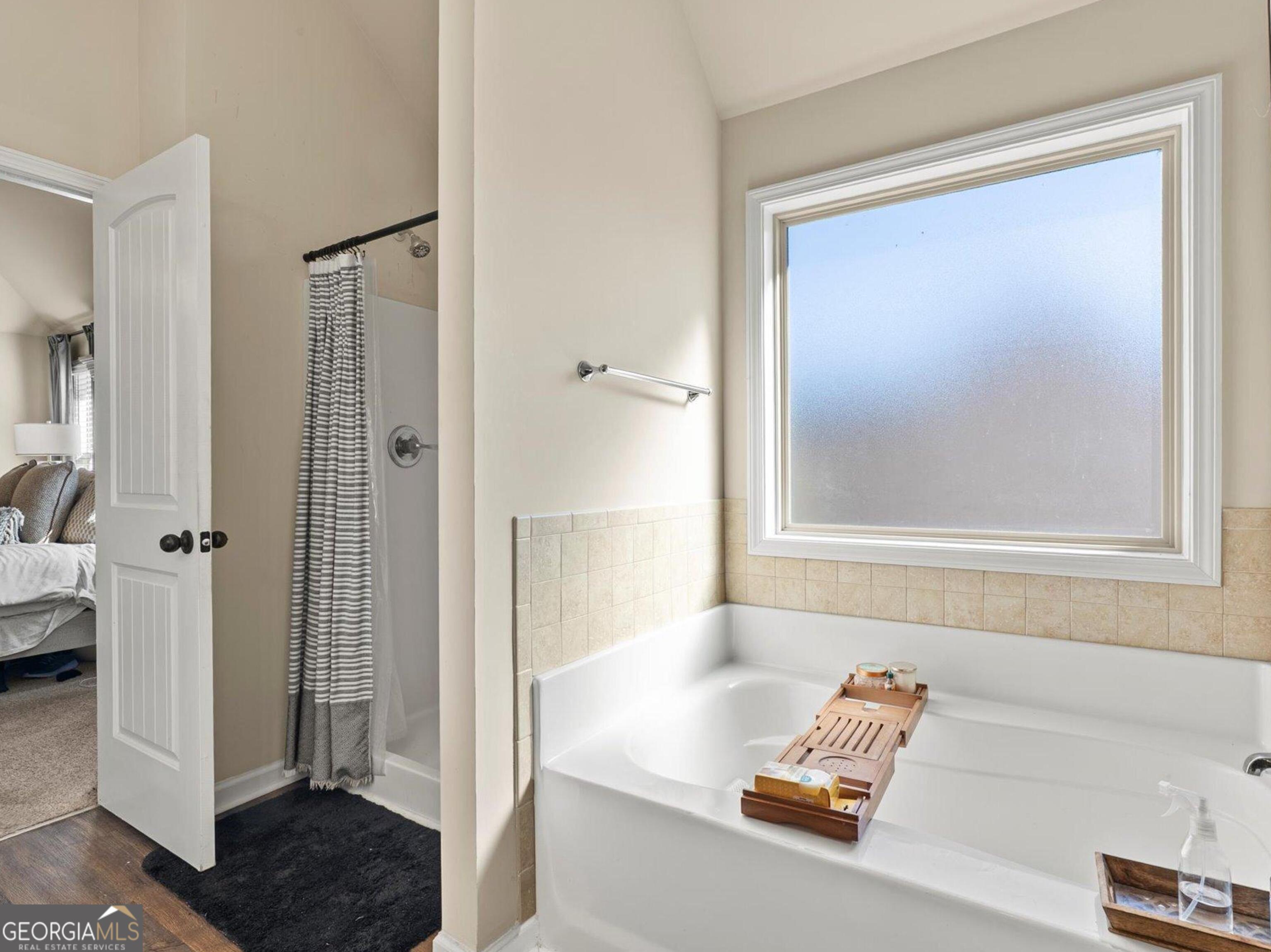 976 Jackson Street Locust Grove, GA 30248 - Photo 15 of 17 a bathroom with a tub shower and a sink