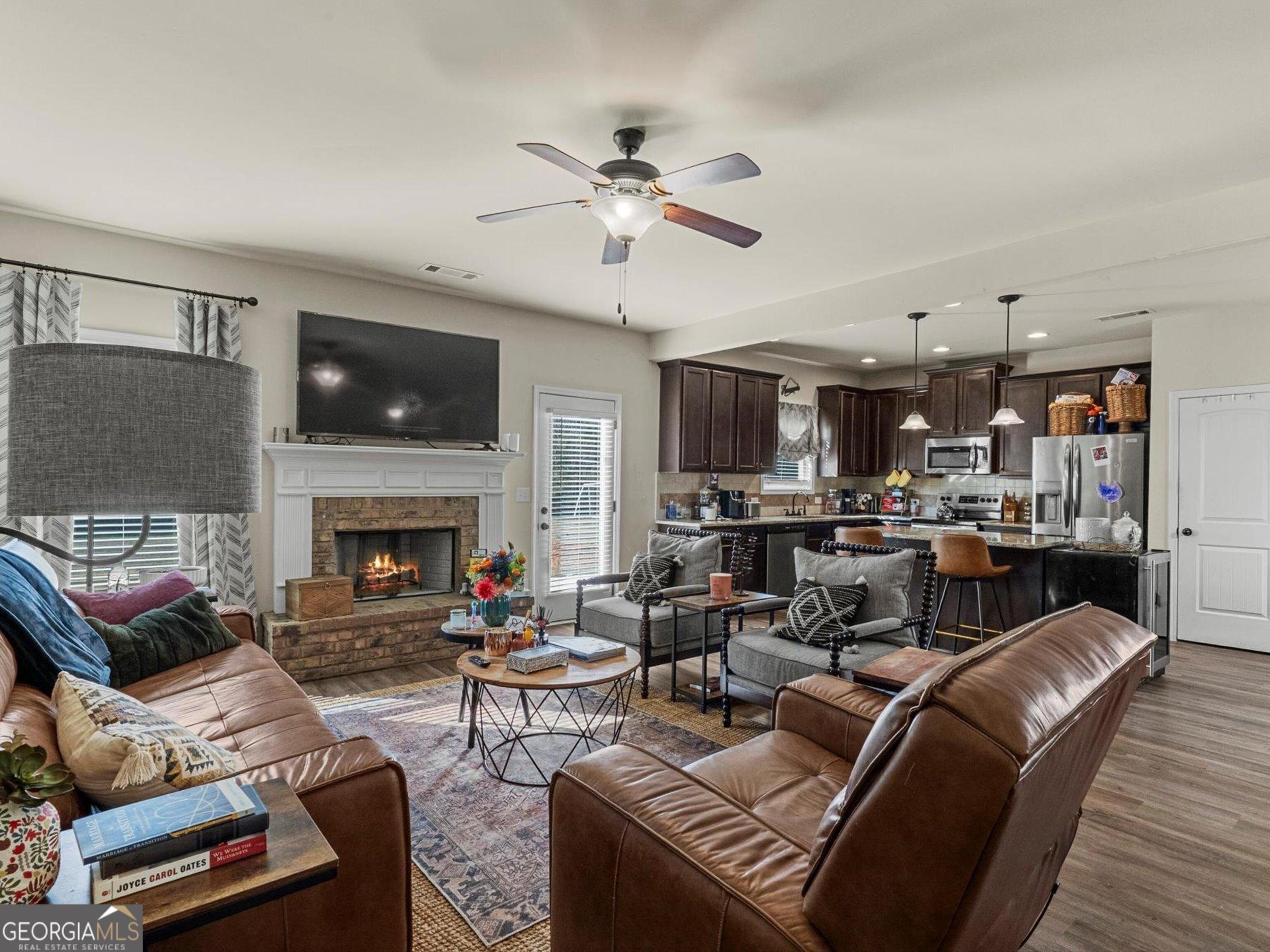976 Jackson Street Locust Grove, GA 30248 - Photo 9 of 17 a living room with furniture fireplace and a flat screen tv
