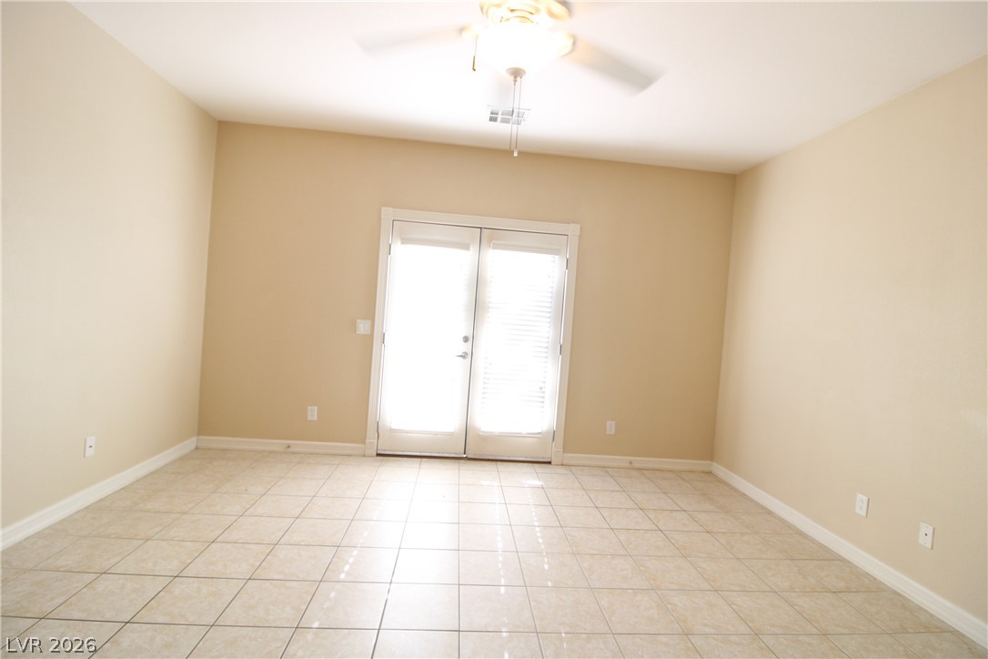 754 Rise Canyon Drive Henderson, NV 89052 - Photo 26 of 34 Natural light streams into this versatile space with direct outdoor access and durable tile flooring.