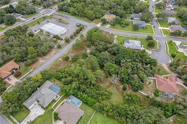 an aerial view of a house with garden space and street view