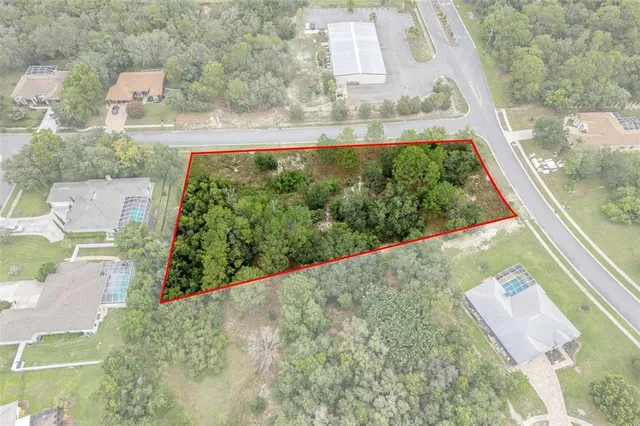 an aerial view of a residential houses with a yard