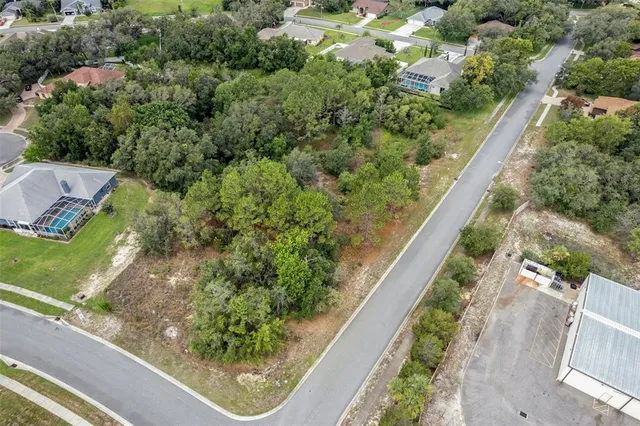 an aerial view of residential house with outdoor space and trees around