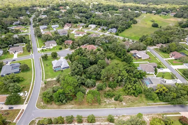 an aerial view of residential houses with outdoor space and street view