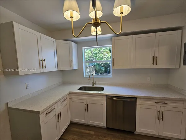 a kitchen with a sink cabinets and window