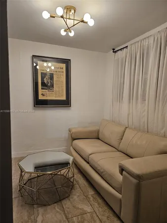 a living room with furniture a couch and a window