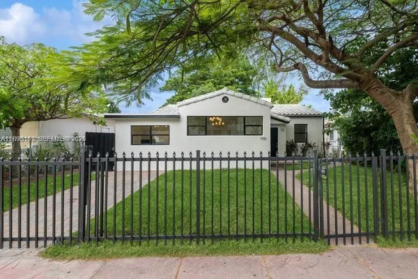 a view of a house with a backyard and a garden