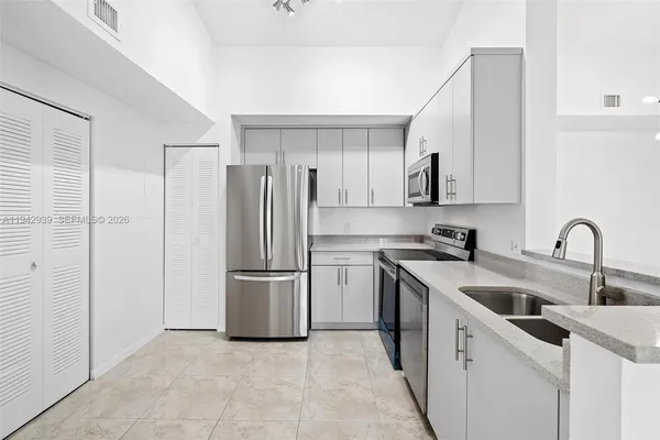 a kitchen with stainless steel appliances granite countertop a refrigerator sink and cabinets