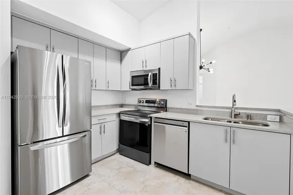 a kitchen with cabinets stainless steel appliances and a sink