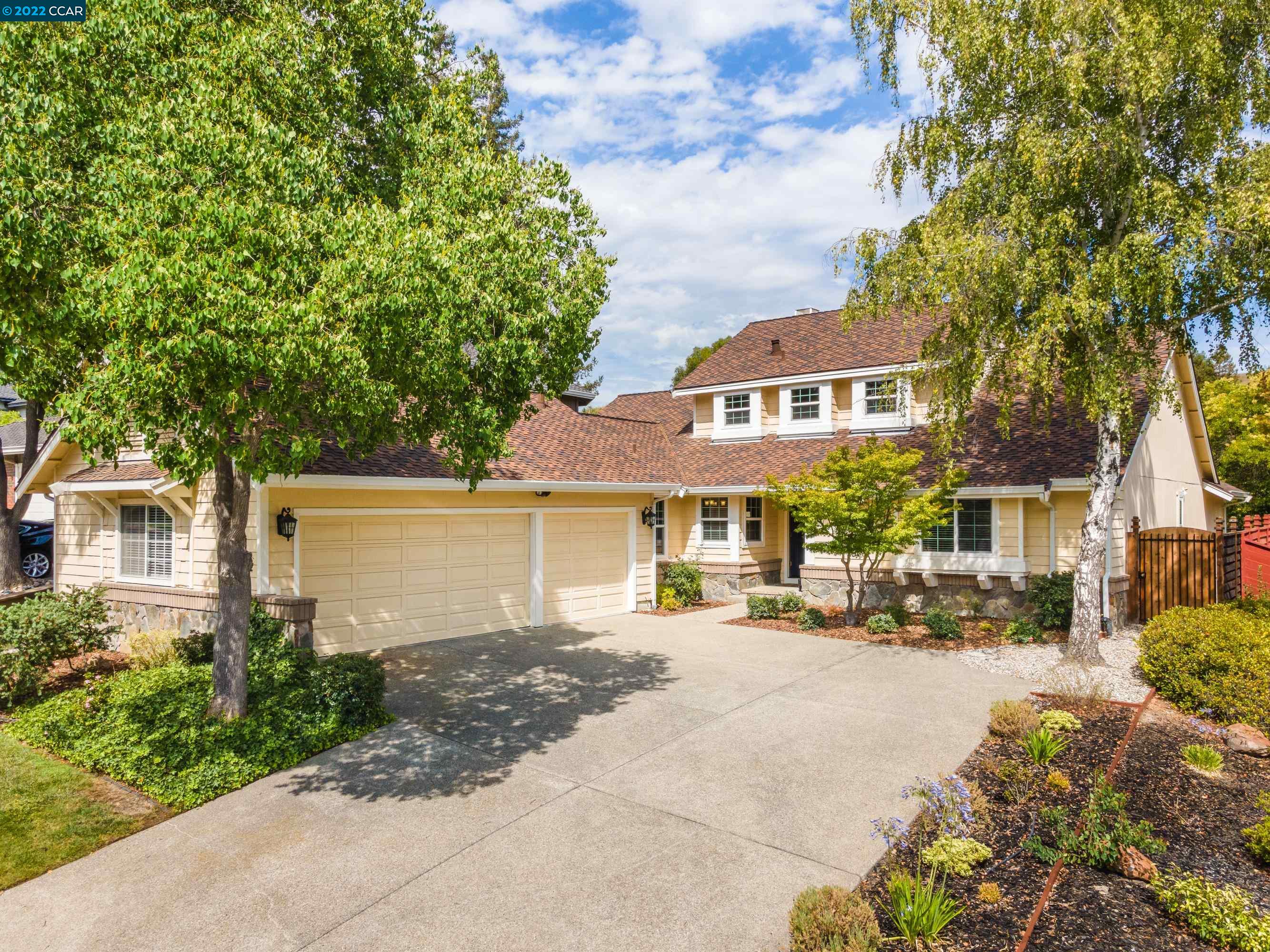 1044 Canyon Hills Road San Ramon, CA 94582 - Photo 1 of 1 a front view of a house with a yard and table and chairs