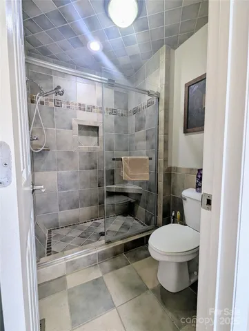a bathroom with a toilet and a shower