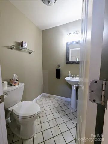 a bathroom with a sink toilet and mirror