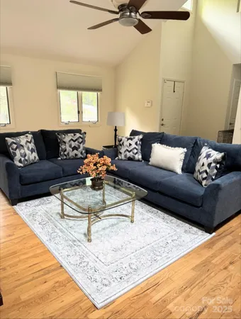a living room with furniture and a wooden floor
