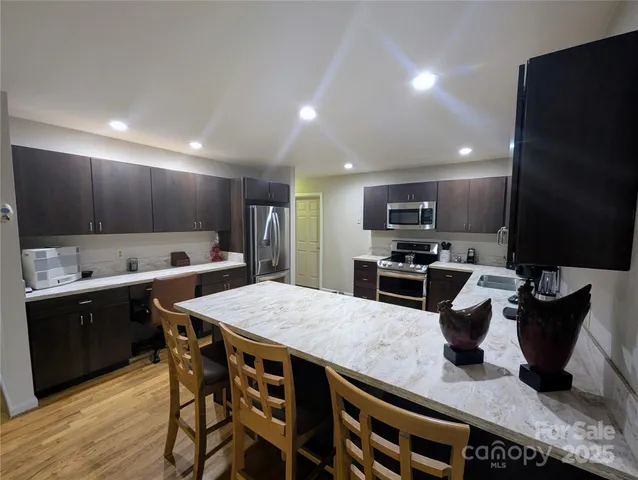 a kitchen with stainless steel appliances granite countertop a sink counter space and cabinets
