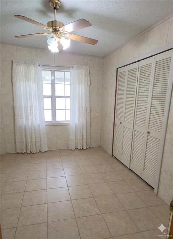 4347 Highway 83 Rio Grande City, TX 78582 - Photo 11 of 15 This room features tiled flooring, a ceiling fan with integrated lighting, and louvered bifold closet doors
