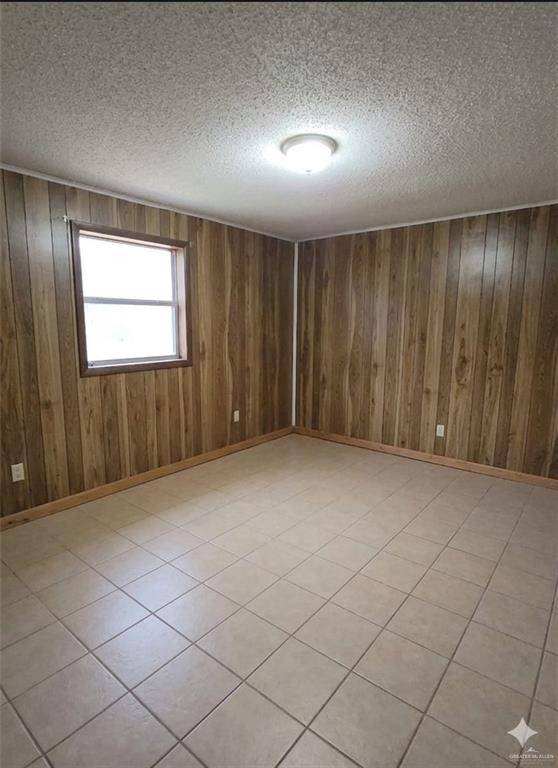 4347 Highway 83 Rio Grande City, TX 78582 - Photo 4 of 15 This room features wood paneling, a window, and tiled flooring