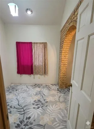 a view of a room with red walls and window