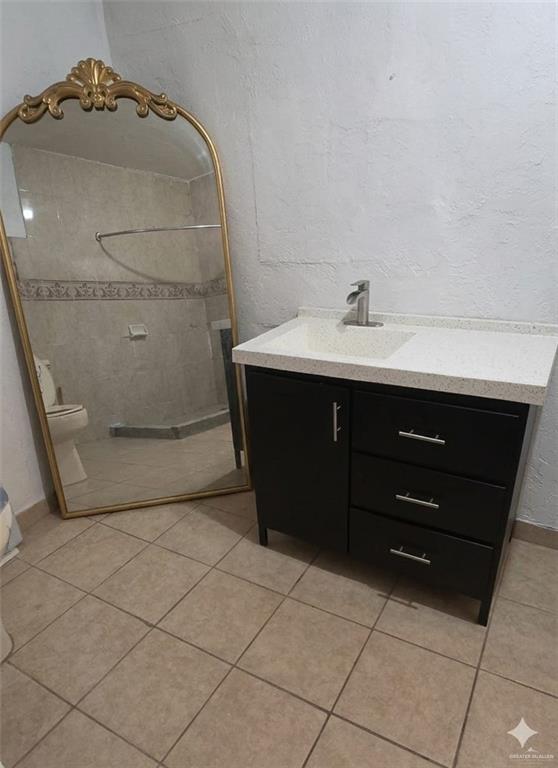 4347 Highway 83 Rio Grande City, TX 78582 - Photo 9 of 15 Bathroom vanity featuring a light-colored countertop, a single sink, and dark cabinetry with silver-toned hardware
