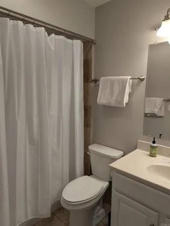 a bathroom with a toilet and a shower