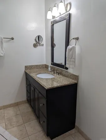 a bedroom with a bed and a lamp