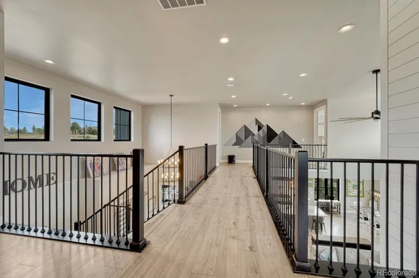 a living room with furniture flat screen tv and wooden floor