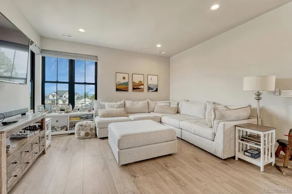 a spacious bedroom with a bed and a couch