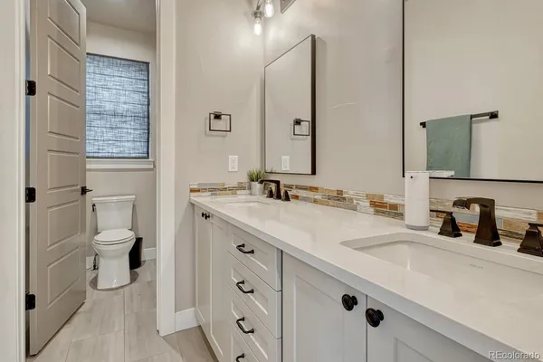 a bedroom with a bed next to a window