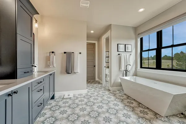 a spacious bathroom with a double vanity sink and a mirror