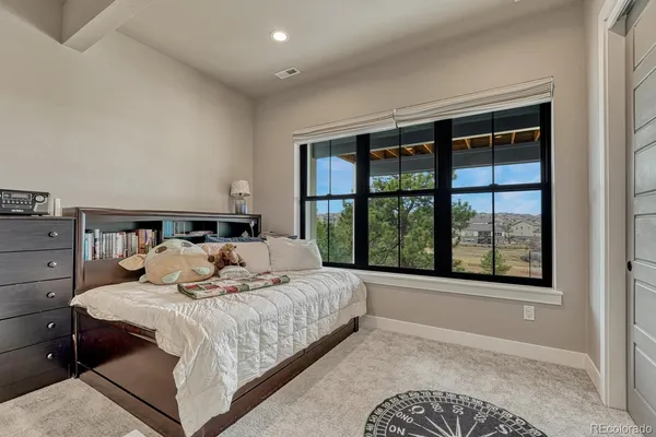 a living room with furniture a rug and white walls