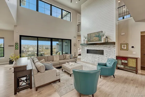 a living room with furniture a large window and a fireplace