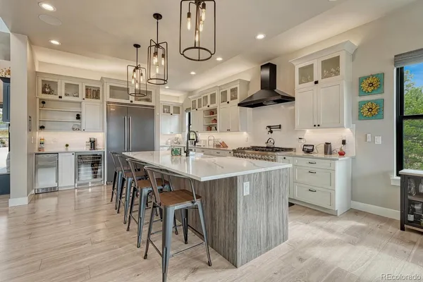 a kitchen with cabinets and chairs