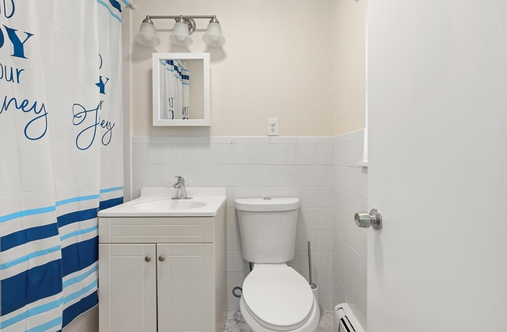 2 Colonial Drive, Unit E25 Andover, MA 01810 - Photo 12 of 17 a bathroom with a toilet sink and mirror